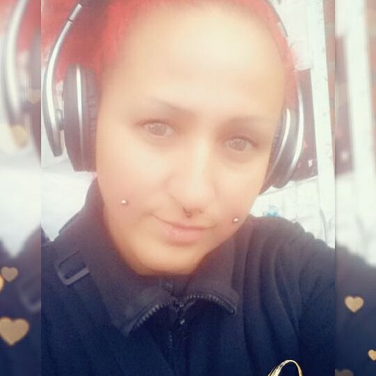 a girl with red hair and headphones