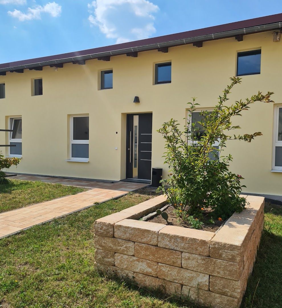 a house with a garden and a stone wall