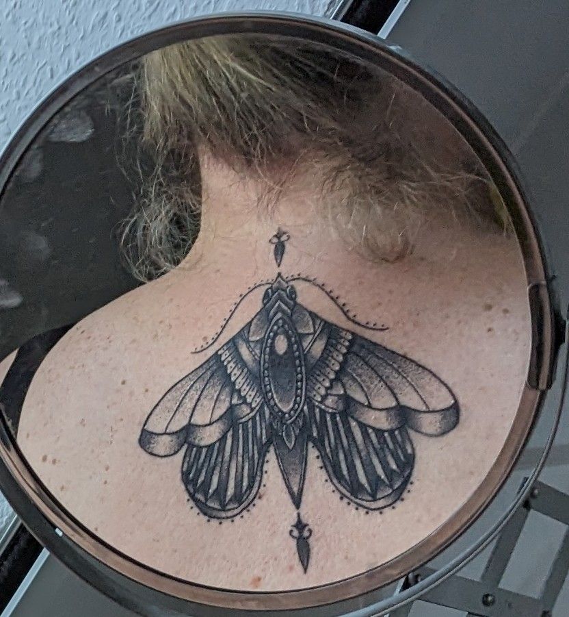 a woman with a moth narben tattoo on her back, berlin, germany