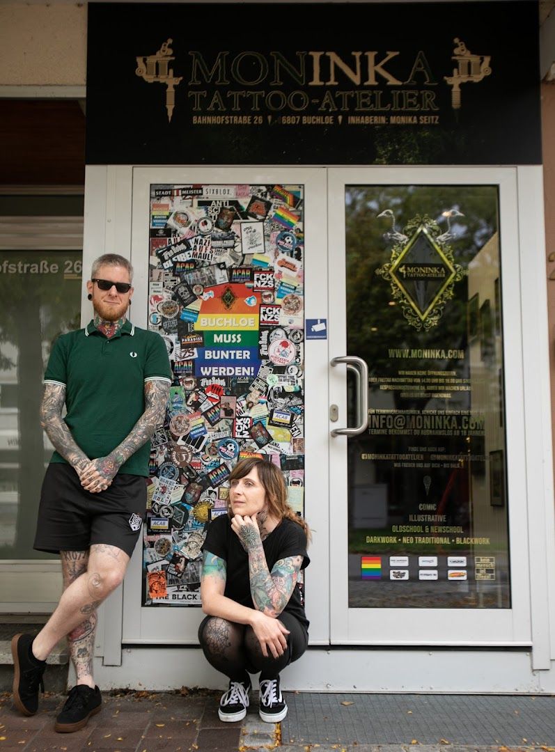 a man and woman sitting in front of a store