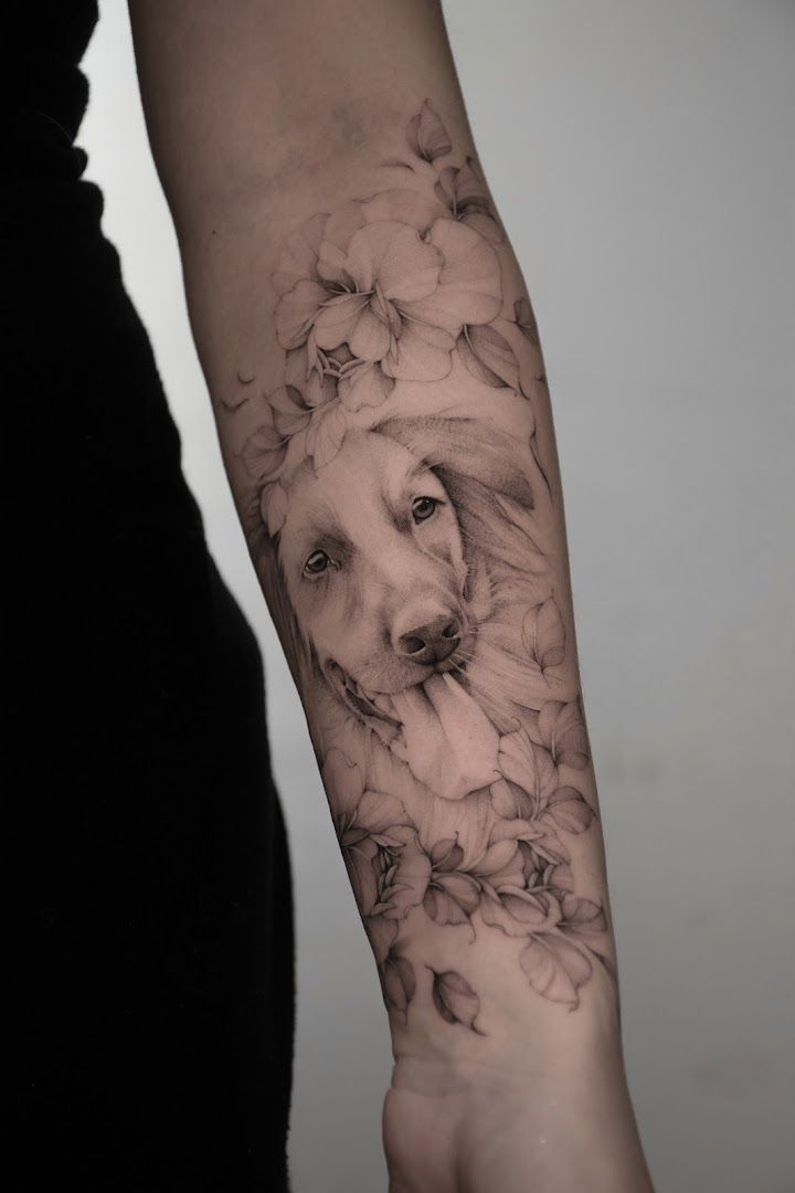 a woman's arm with a black and white cover-up tattoo of a dog, wetteraukreis, germany