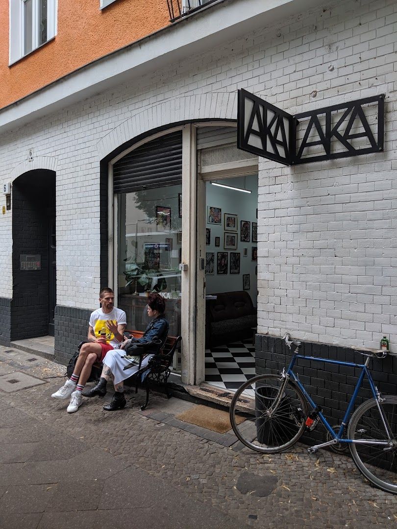 a man sitting on the sidewalk next to a bike