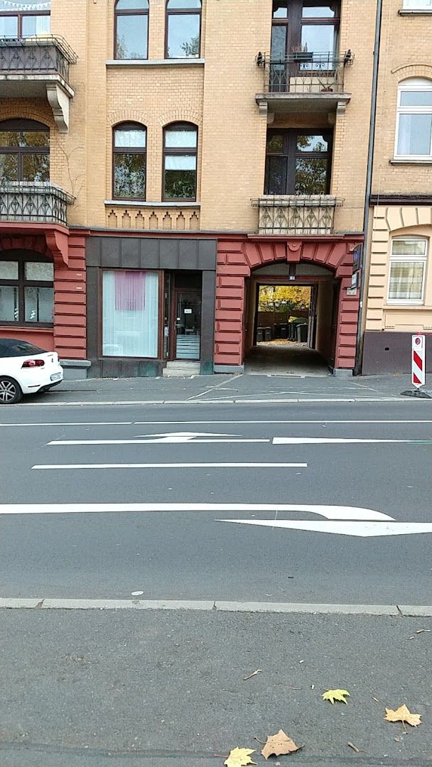 a white car parked in front of a building