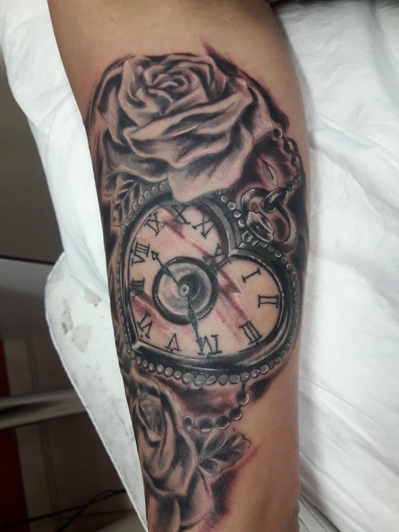 a cover-up tattoo with a rose and a clock, berlin, germany