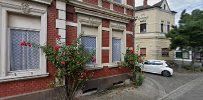 a red brick building with a white car parked in front