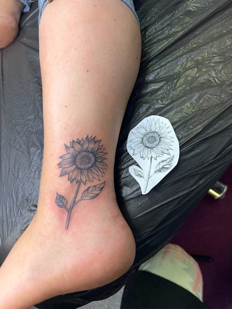 a portrait tattoos of a sunflower on the ankle, neuburg-schrobenhausen, germany