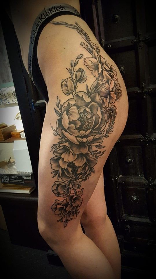 a woman's thigh with a cover-up tattoo of flowers, mönchengladbach, germany