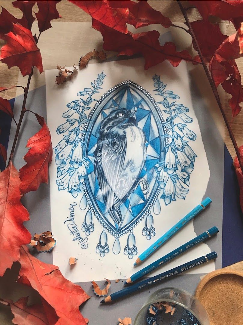 a blue bird with a crown on it's head sits on a piece of paper surrounded by