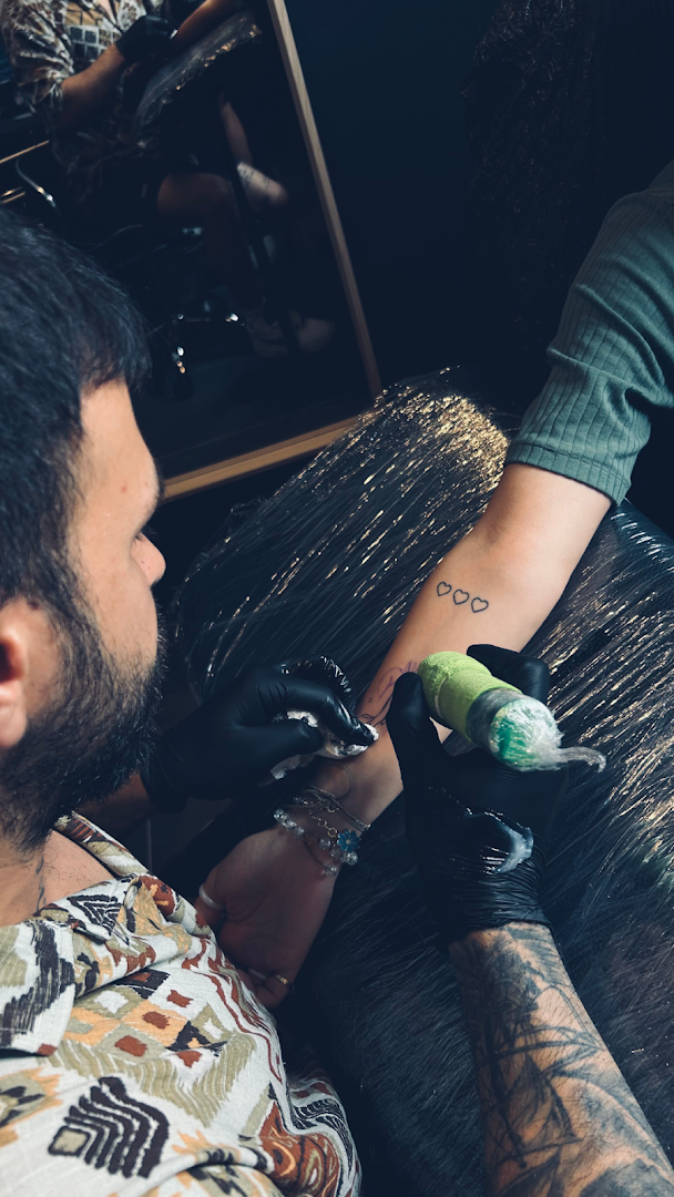 a man getting his cover-up tattoo done by a tattoo artist, bremen, germany