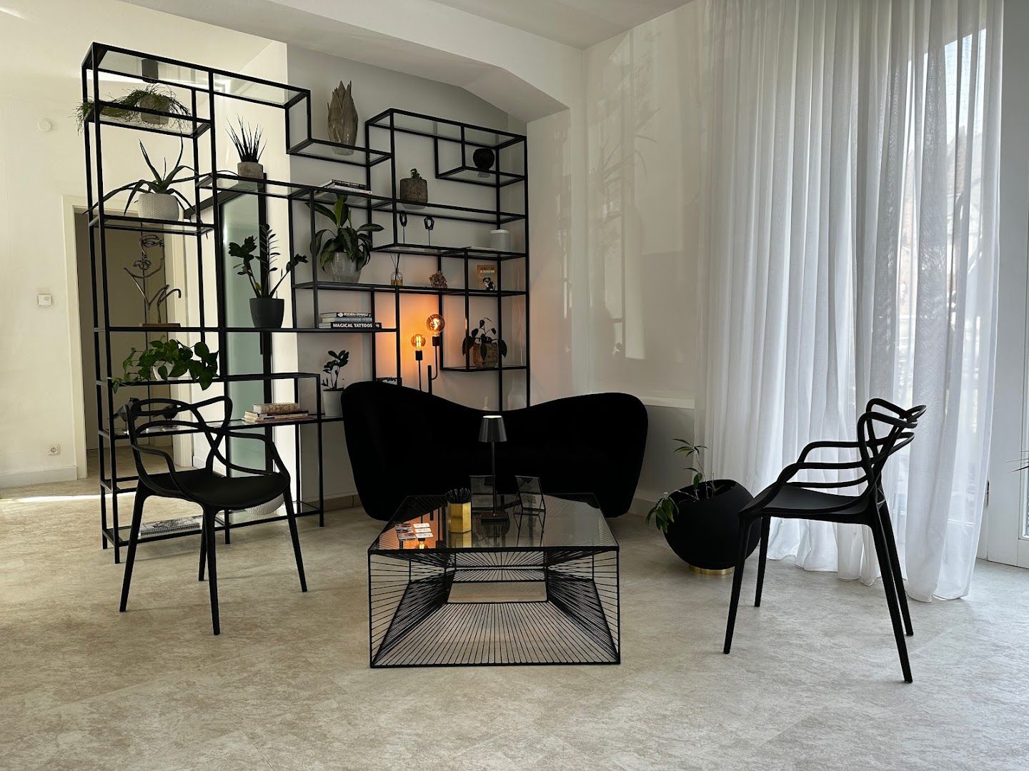 a living room with a black chair and a black table