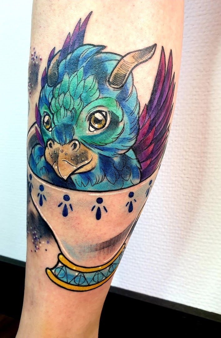 a narben tattoo of a blue bird in a cup, bochum, germany