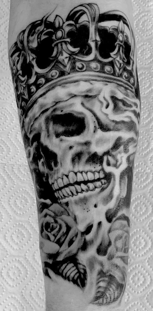 a skull with a crown cover-up tattoo on the arm, göppingen, germany