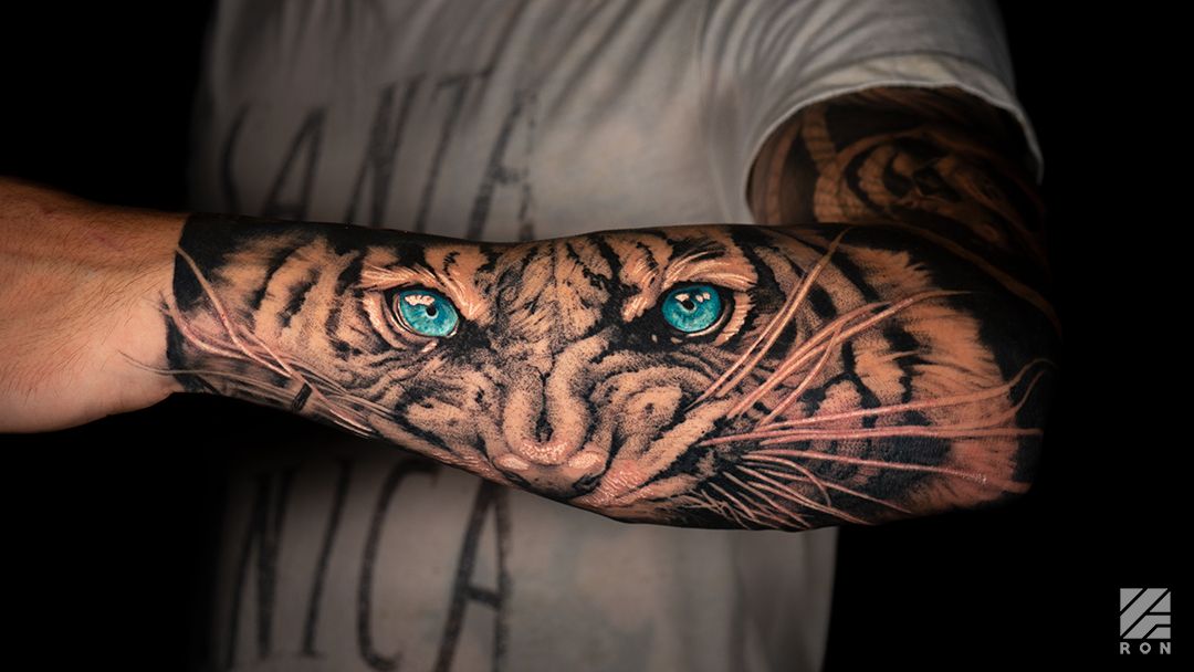 a man's hand with a tiger cover-up tattoo on it, ahrweiler, germany