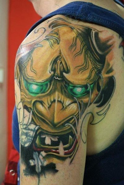 a japanische tattoos in leipzig of a lion with green eyes, bonn, germany