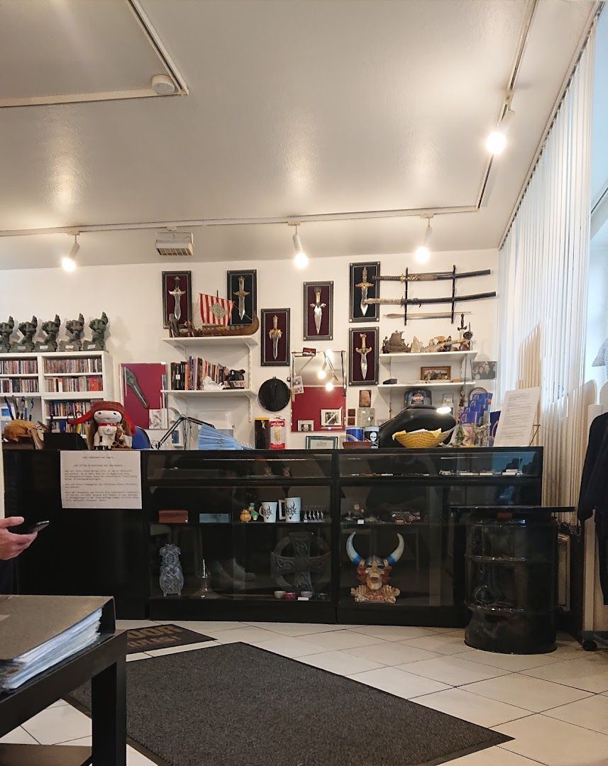 a living room with a black tv and a black cabinet