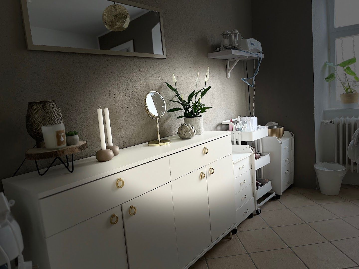 a white dresser sitting next to a white cabinet