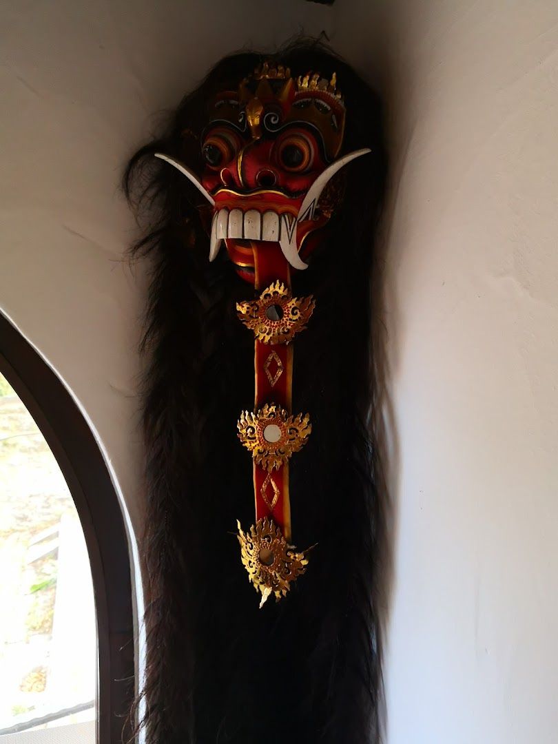 a mask hanging on the wall