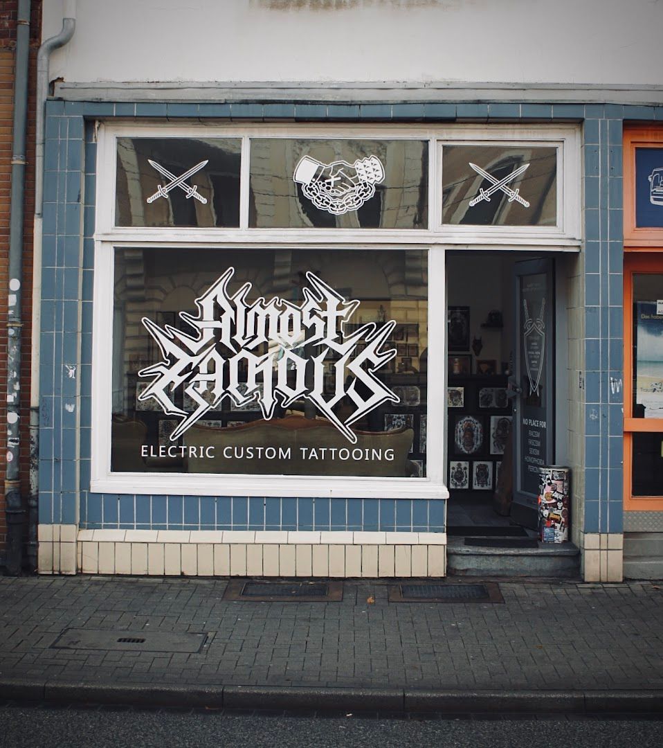 a store front with a sign that says electric narben tattoo, kassel, germany