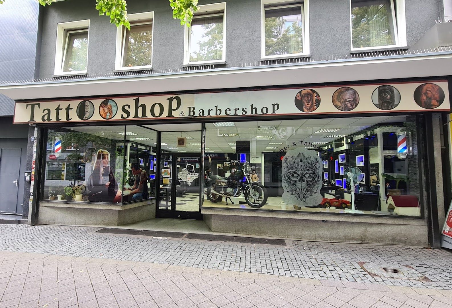 a store front with a sign that says cover-up tattoo shop, essen, germany