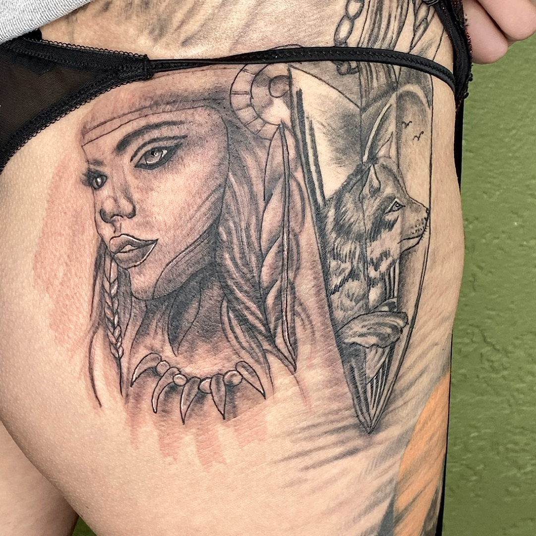 a woman's thigh with a cover-up tattoo of a woman and a cat, diepholz, germany