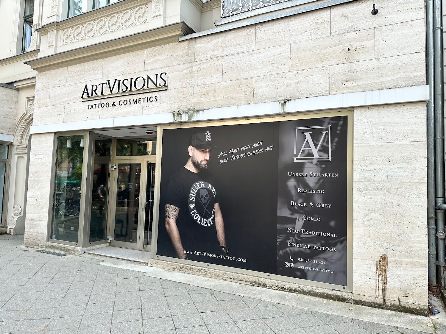 a storefront with a black and white sign