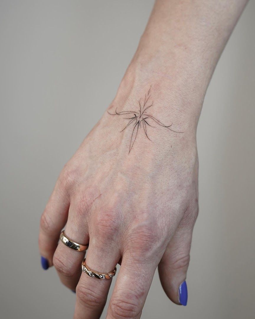 a small spider narben tattoo on the wrist, berlin, germany