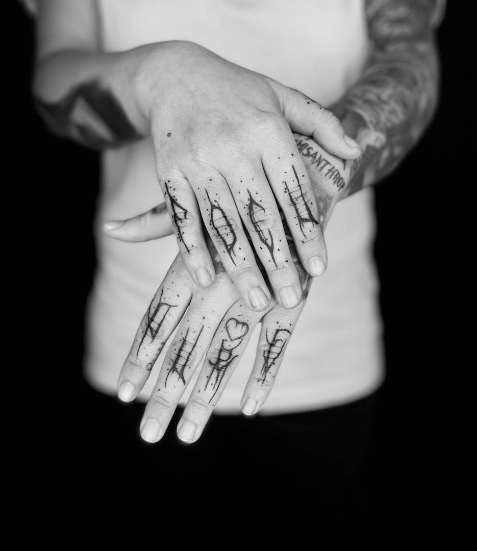 a person with japanische tattoos in leipzigs on their hands, saarlouis, germany