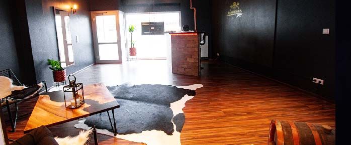 a living room with a cow rug on the floor