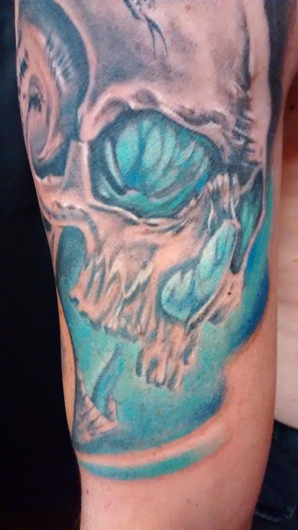 a man with a skull cover-up tattoo on his arm, bielefeld, germany