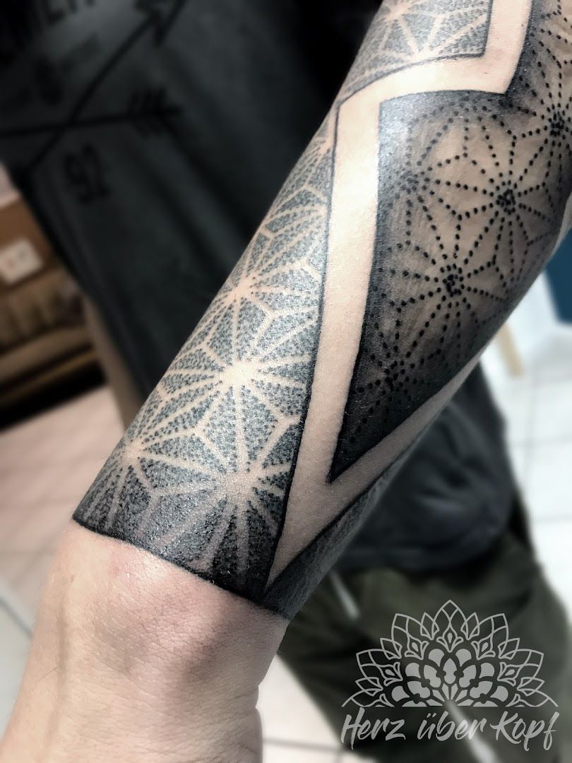 a black and white cover-up tattoo design on the arm, offenbach, germany