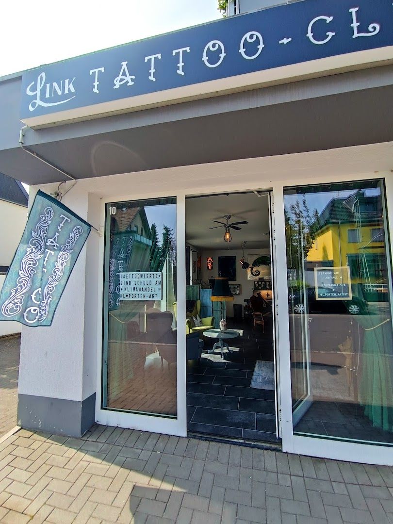 a store front with a sign that says narben tattoo club, rhein-erft district, germany