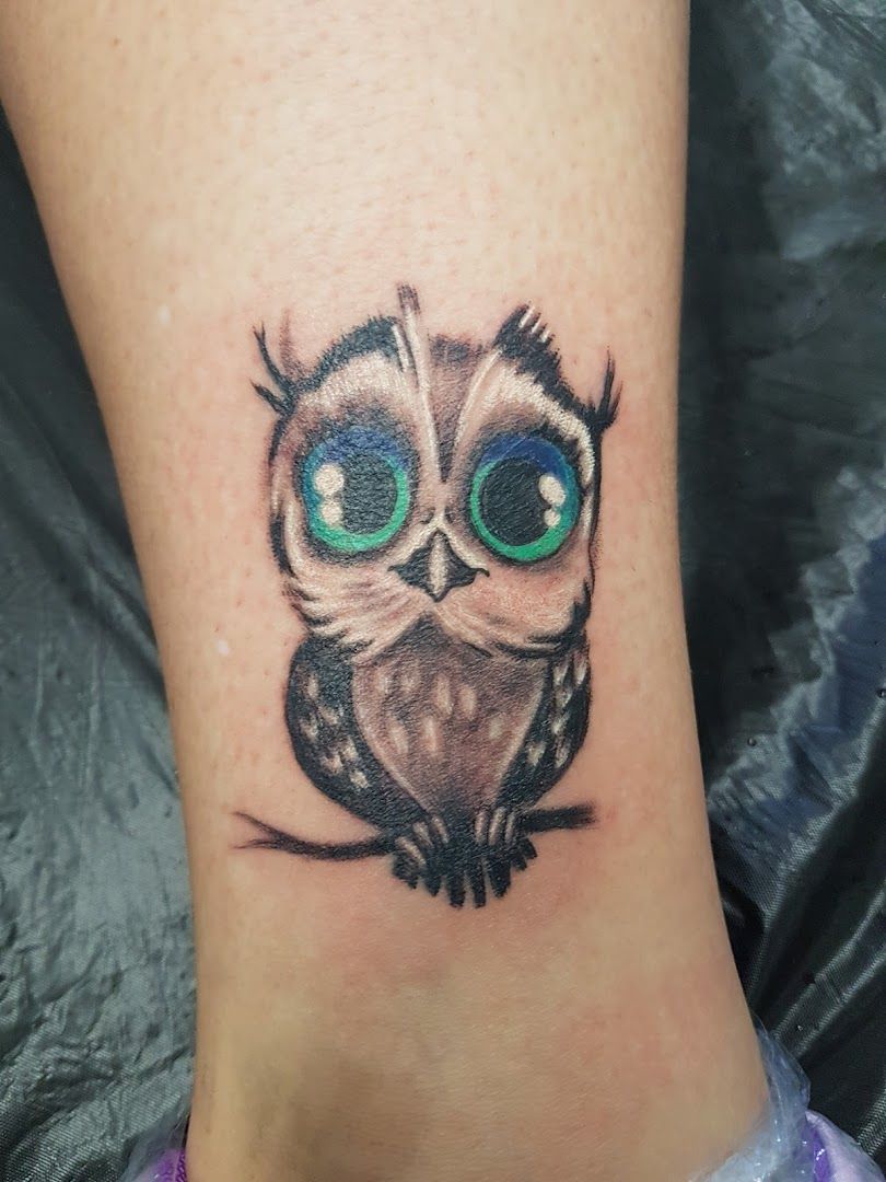 a small owl cover-up tattoo on the ankle, odenwaldkreis, germany