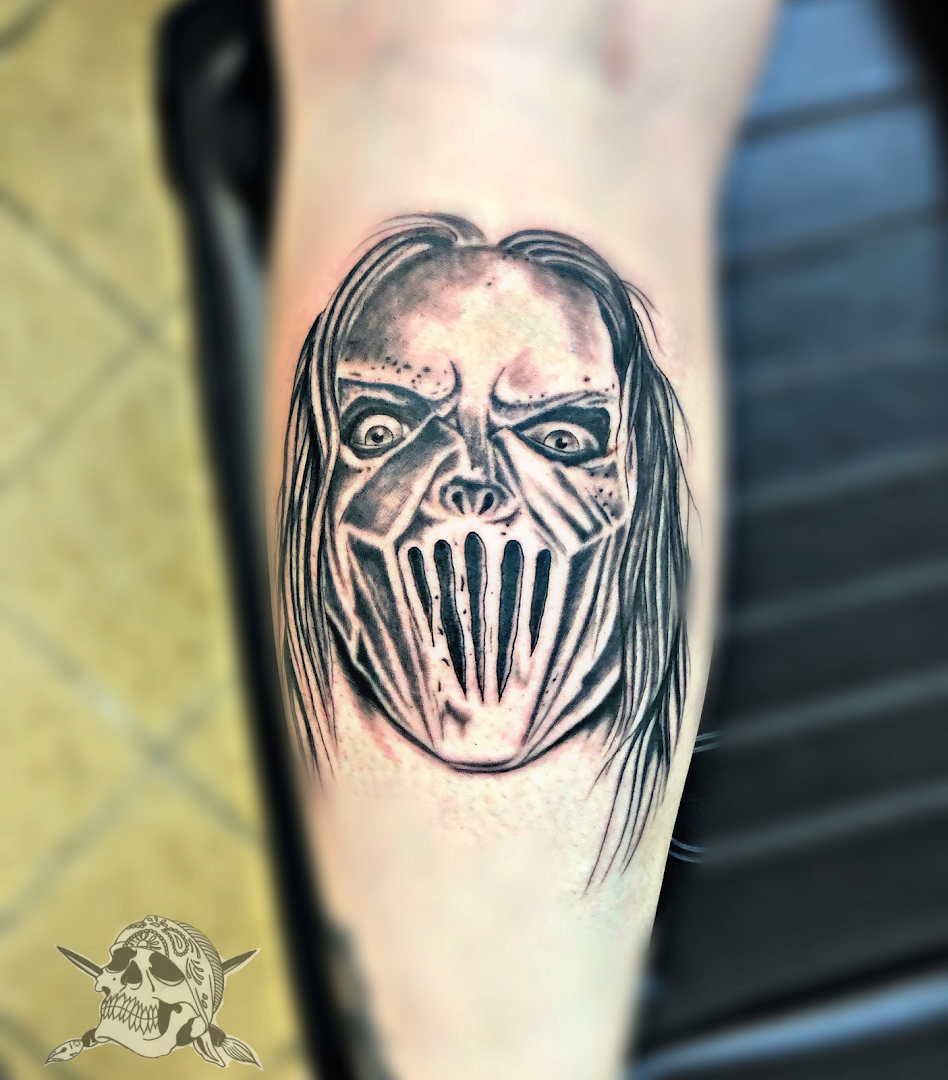 a cover-up tattoo of a demon with a face on the forearm, konstanz, germany