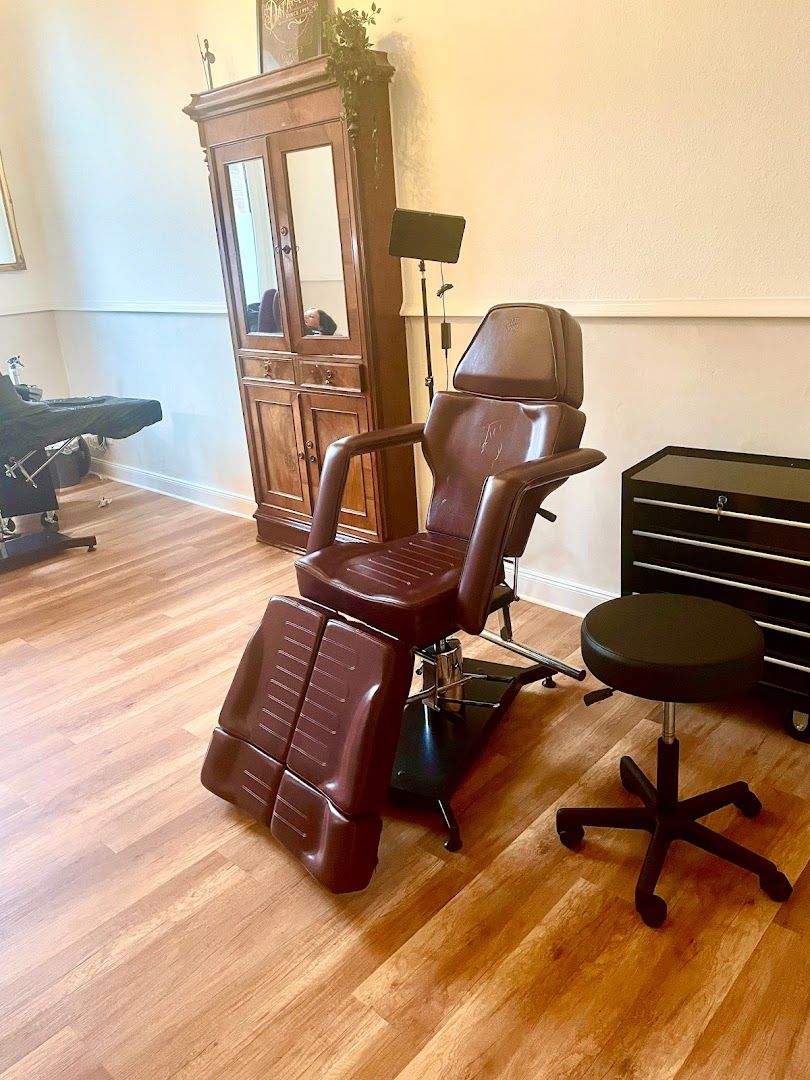a salon chair with a mirror and a chair