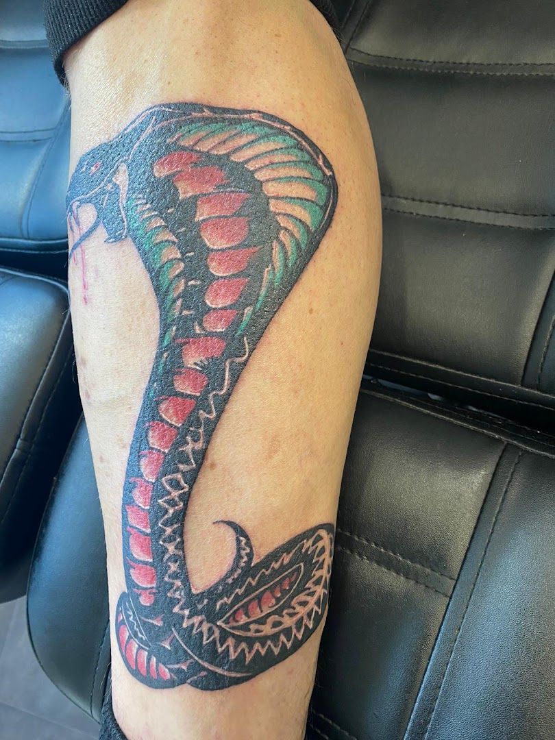 a narben tattoo of a cobra on the arm, nordsachsen, germany