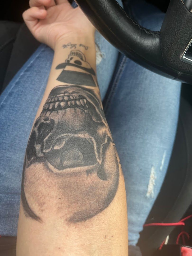 a man's arm with a skull cover-up tattoo on it, märkisch-oderland, germany