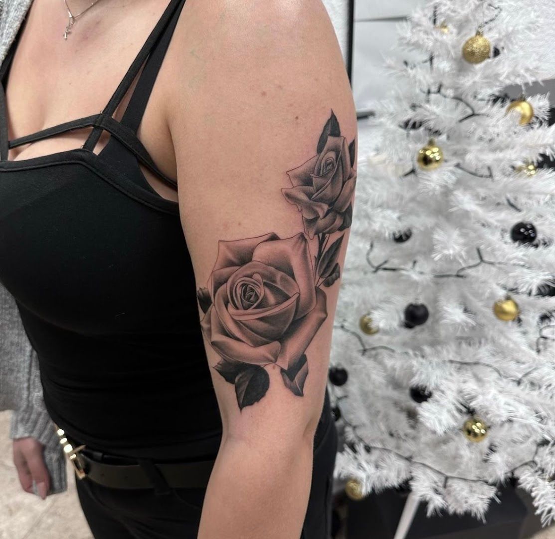 a woman with a rose cover-up tattoo on her arm, sächsische schweiz-osterzgebirge, germany