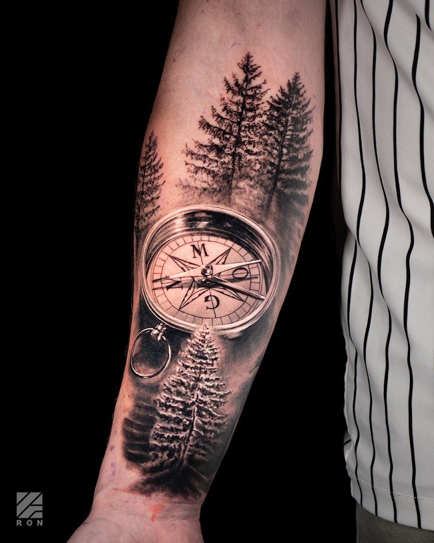 a man with a compass cover-up tattoo on his arm, ahrweiler, germany