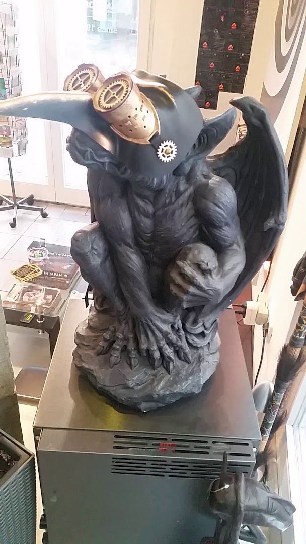 a statue of a demon with a mask on it's head