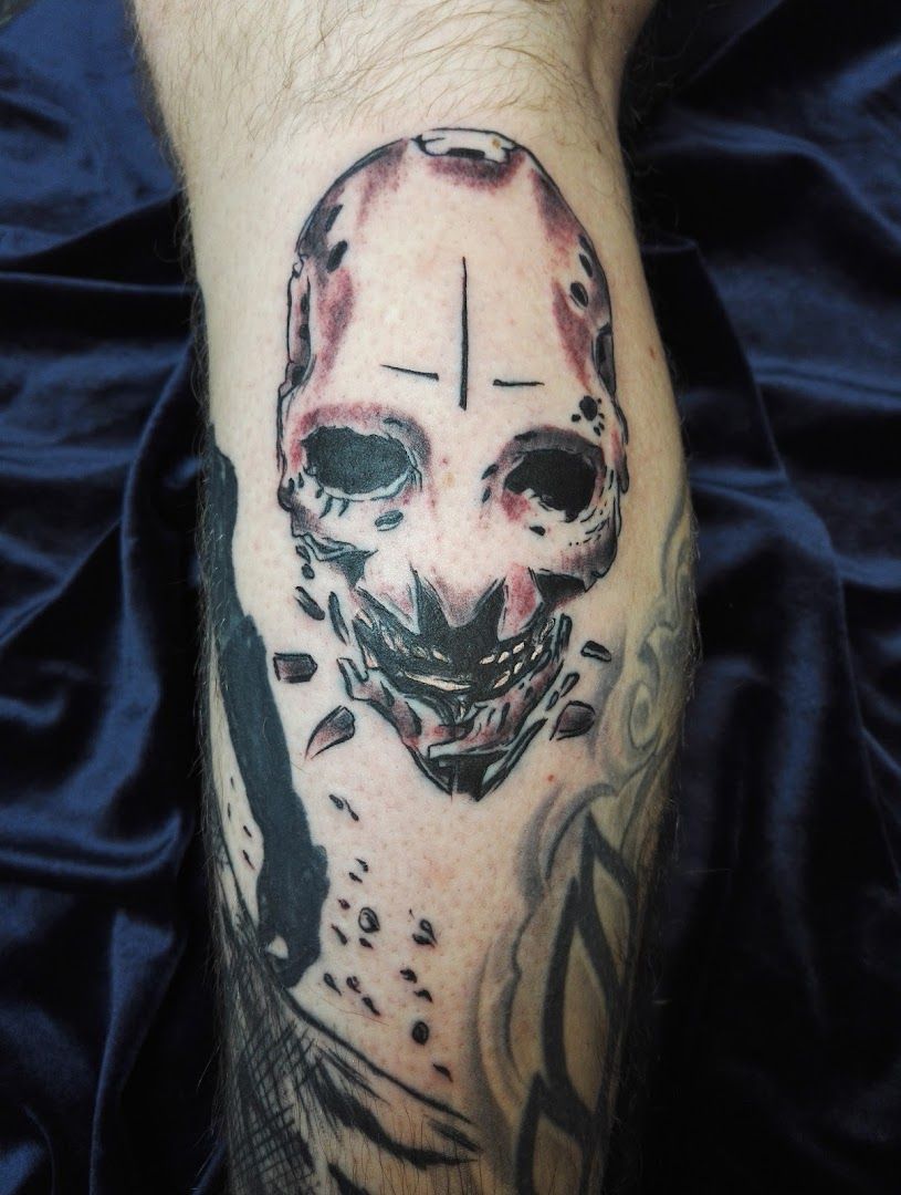 a cover-up tattoo of a skull with a face and a knife, gütersloh, germany