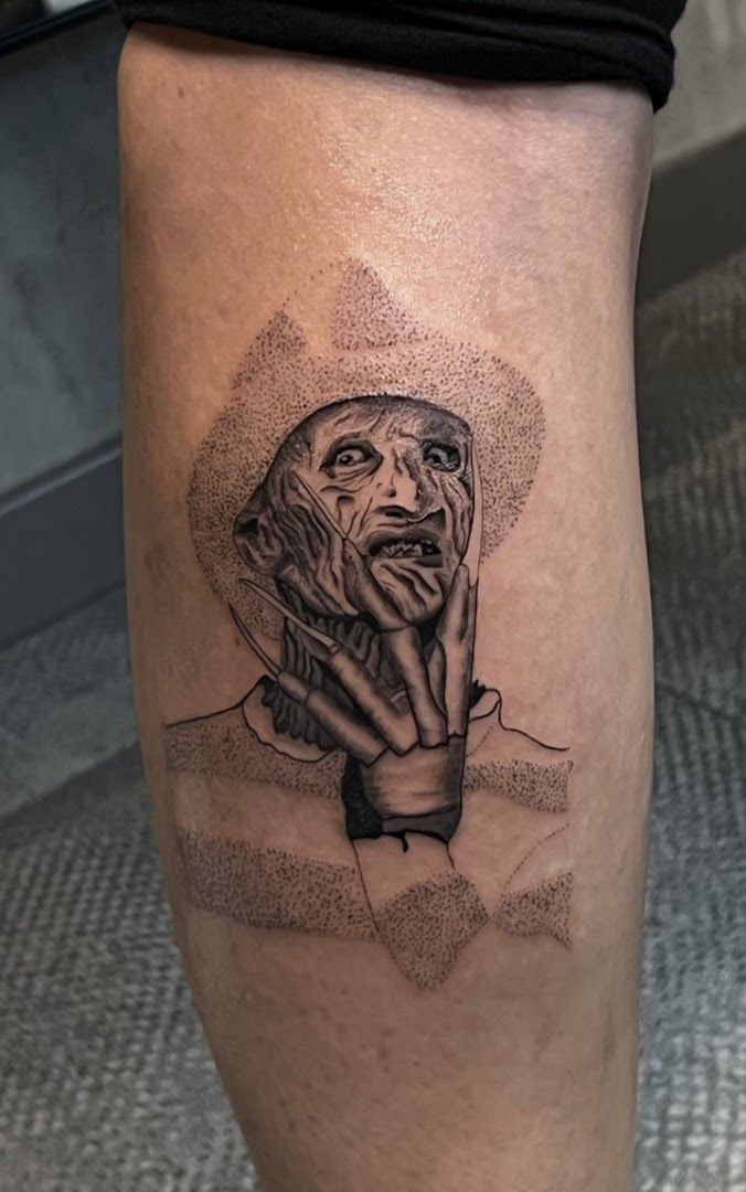 a cover-up tattoo of a woman's face with a hand on her knee, wartburgkreis, germany