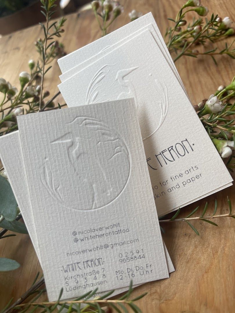 a white business card with a white logo on it