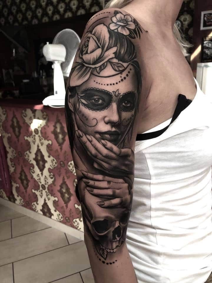 a woman with a skull cover-up tattoo on her arm, salzlandkreis, germany