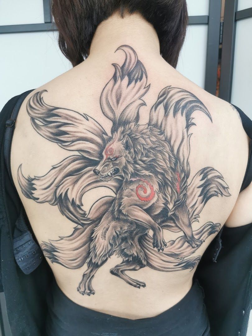 a woman with a cover-up tattoo on her back, mayen-koblenz, germany