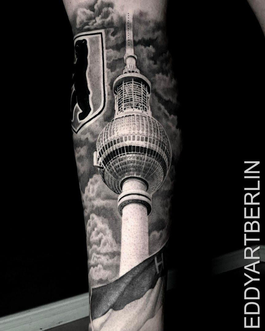 a black and white cover-up tattoo of a berlin tv tower, berlin, germany