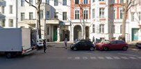 a street with parked cars and buildings