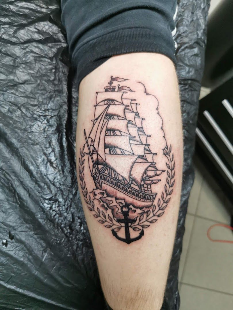 a narben tattoo of a ship with a wreath around it, osnabrück, germany