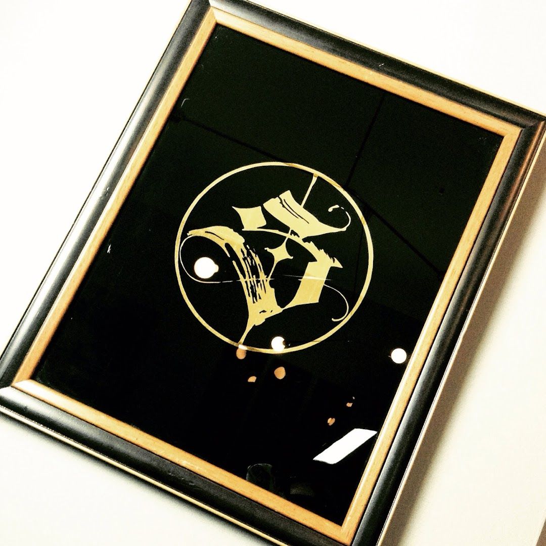 a black and gold framed picture of a man