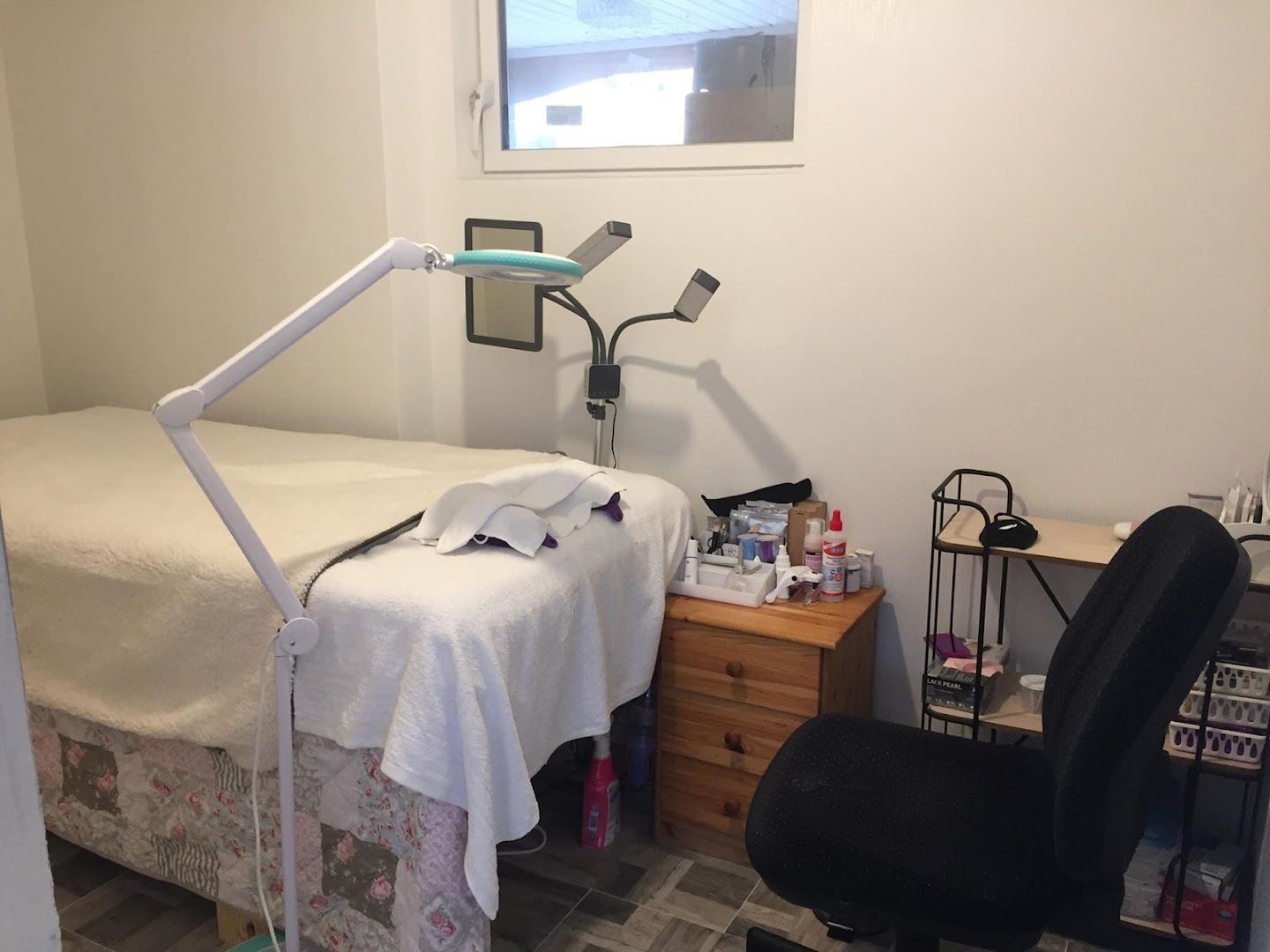 a room with a bed, desk and chair