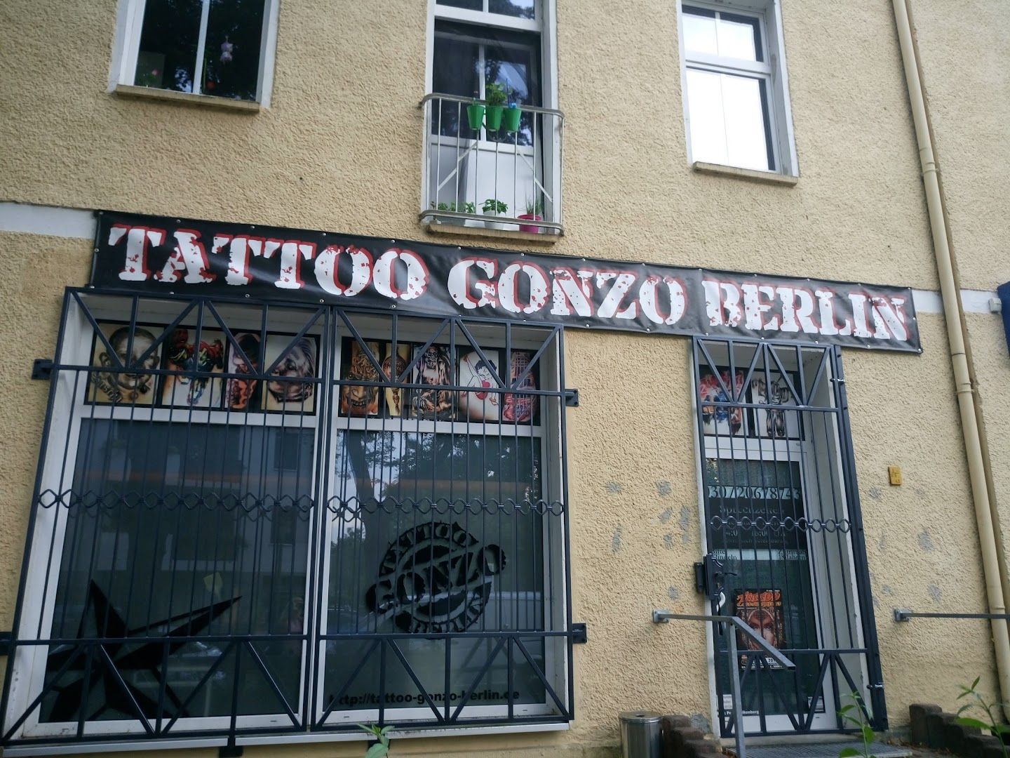 a building with a sign that says narben tattoo corb, berlin, germany